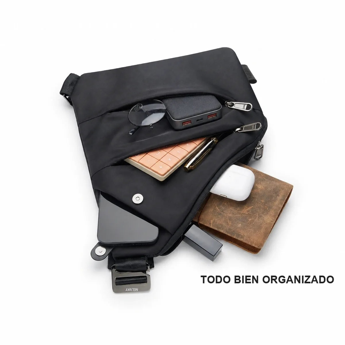 Bolso NELVAY abierto con celular, cartera, lentes y llaves ordenados